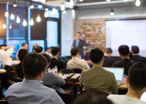 People sat in a workshop, photo taken from the back of the room